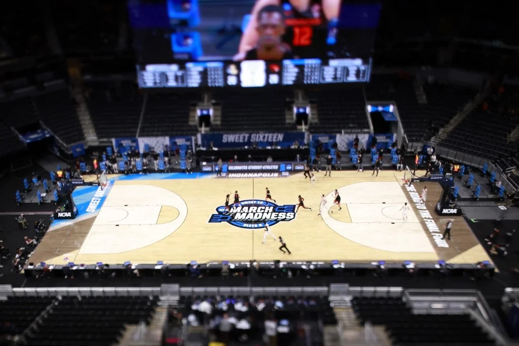The March Madness logo on the court