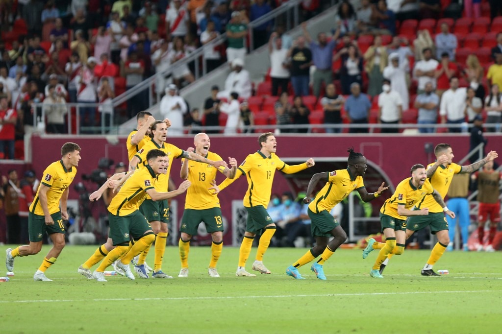 Australia's players celebrate after winning the FIFA World Cup 2022 inter-confederation play-offs match between Australia and Peru
