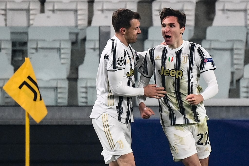 Juventus' Italian forward Federico Chiesa (R) celebrates after scoring his second goal during the UEFA Champions League