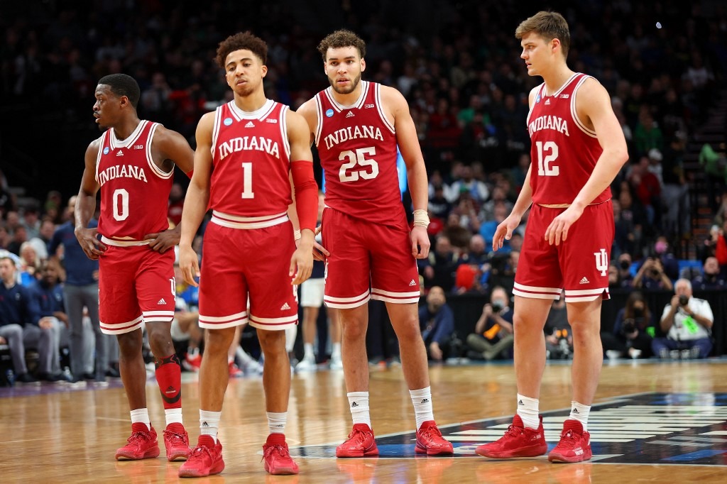 Xavier Johnson #0, Rob Phinisee #1, Race Thompson #25, and Miller Kopp #12 of the Indiana Hoosiers stand on the court