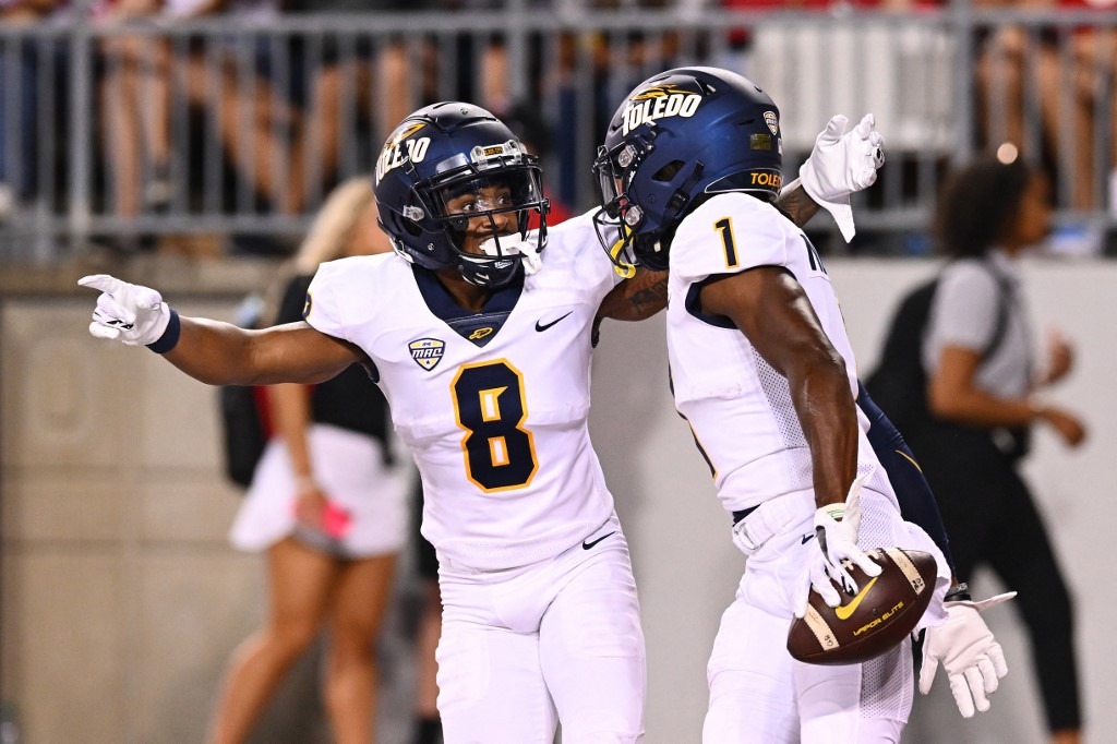 Jerjuan Newton #1 of the Toledo Rockets celebrates his third quarter touchdown with teammate Devin Maddox #8 of the Toledo Rockets