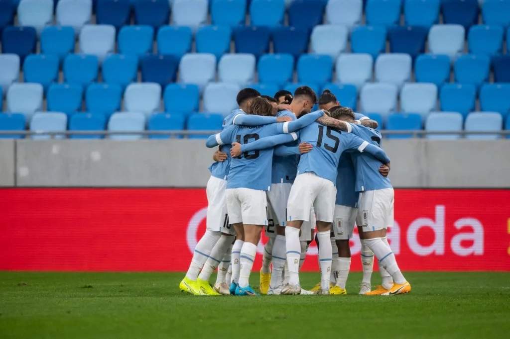 Uruguay’s players celebrate scoring the opening goal