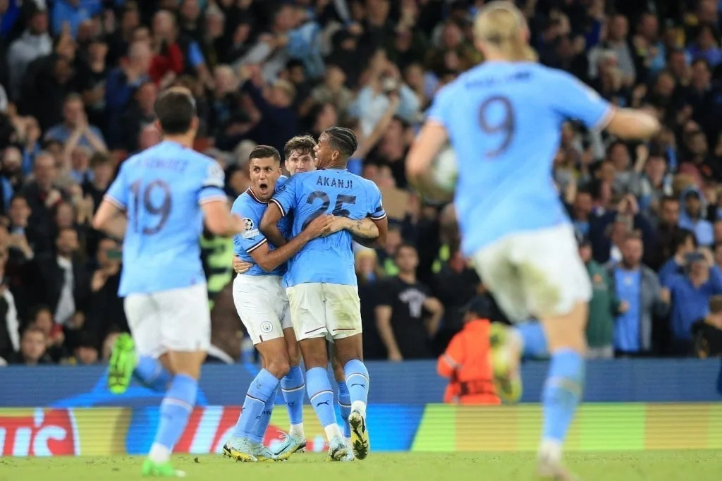 Manchester City's English defender John Stones (C) celebrates with teammates after scoring the equaliser during the UEFA Champions League group G football match.
