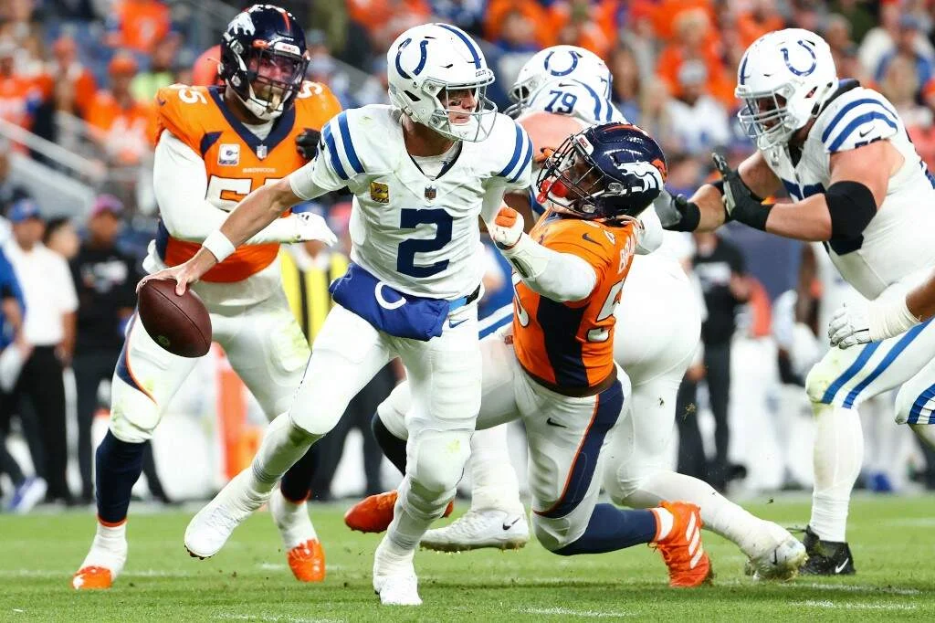 Matt Ryan #2 of the Indianapolis Colts scrambles away from Baron Browning #56 of the Denver Broncos