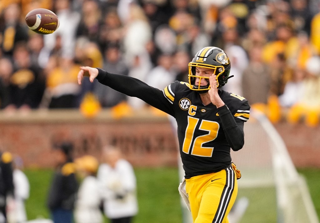 Brady Cook #12 of the Missouri Tigers throws a pass during the first half