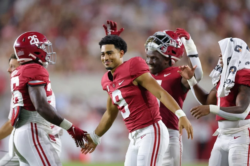 Bryce Young #9 of the Alabama Crimson Tide celebrates with teammate Jamarion Miller #26 after a touchdown