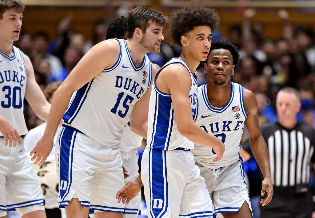 Ryan Young #15, Tyrese Proctor #5 and Jeremy Roach #3 of the Duke Blue Devils talk during the second half
