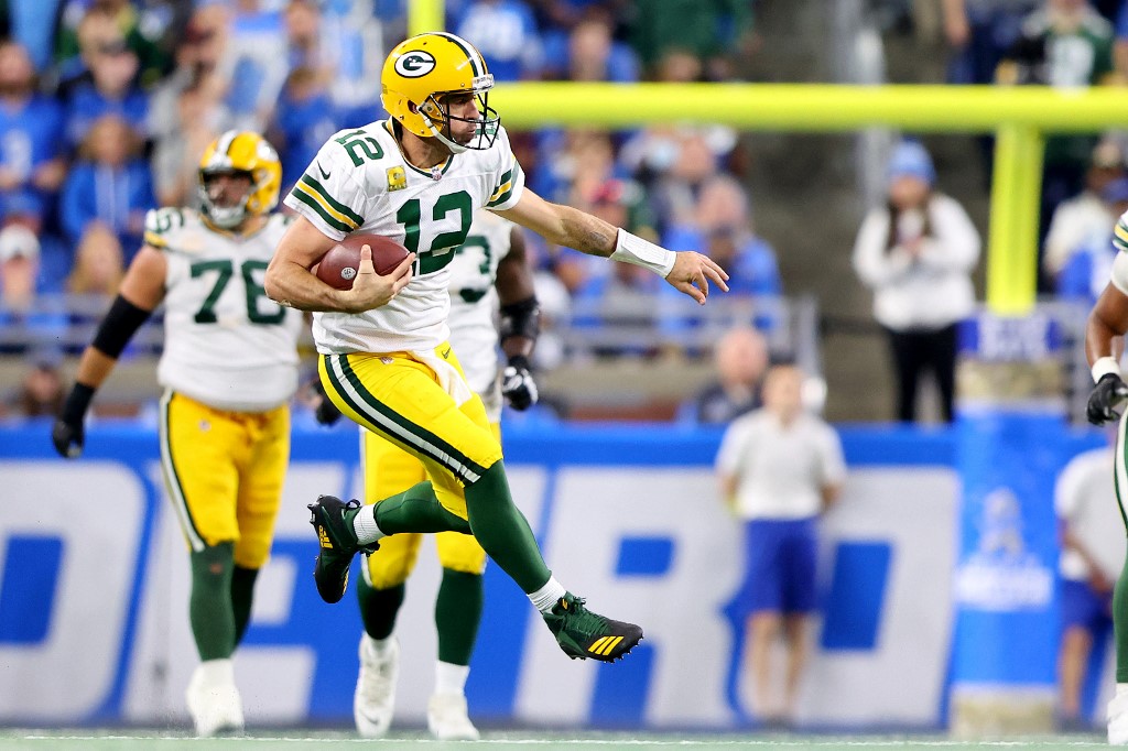 Aaron Rodgers #12 of the Green Bay Packers carries the ball against the Detroit Lions during the fourth quarter at Ford Field on November 06