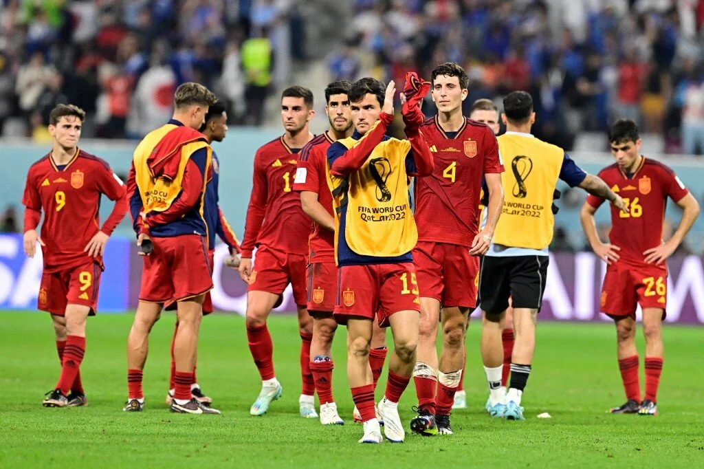 Spain's teammates react at the end of the Qatar 2022 World Cup