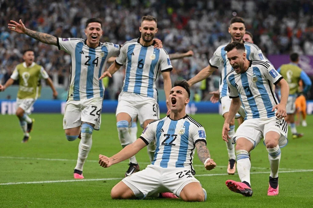 Argentina's forward #22 Lautaro Martinez celebrates after scoring his penalty and qualifying to the next round