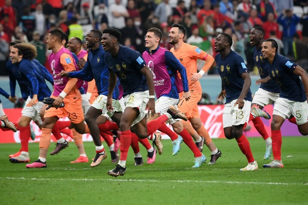 France's players celebrate their victory in the Qatar 2022 World Cup semi-final football match between France and Morocco
