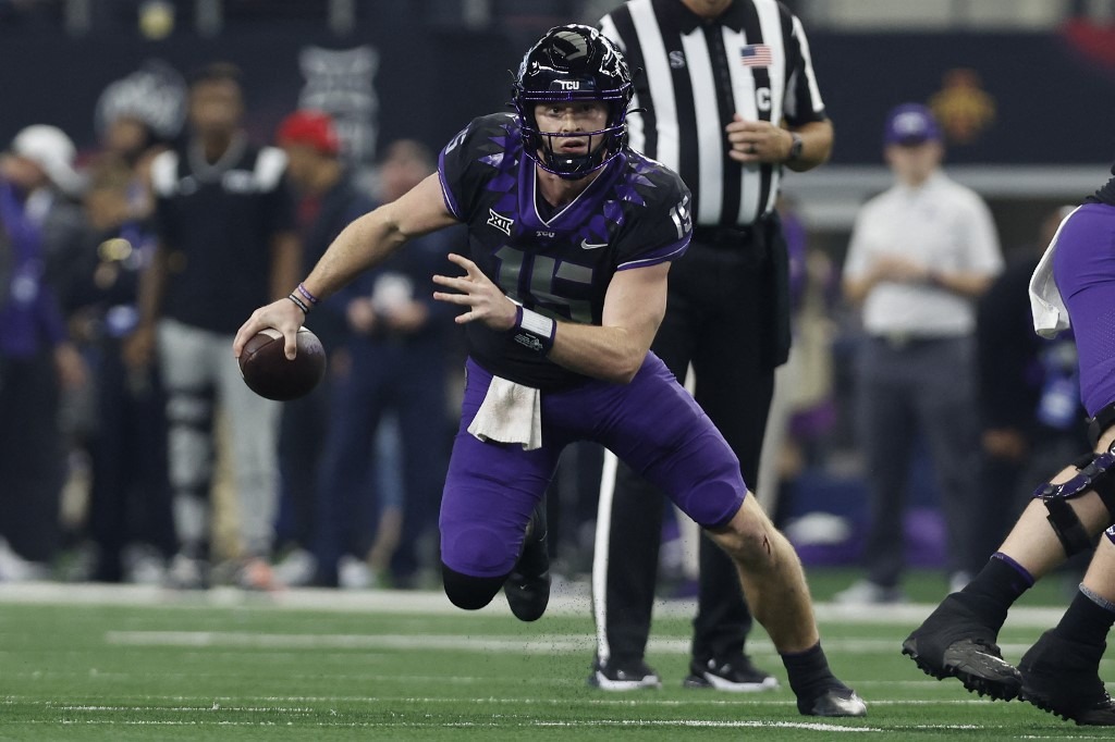 Quarterback Max Duggan #15 of the TCU Horned Frogs scrambles in the pocket against the Kansas State Wildcats in the first half of the Big 12 Championship
