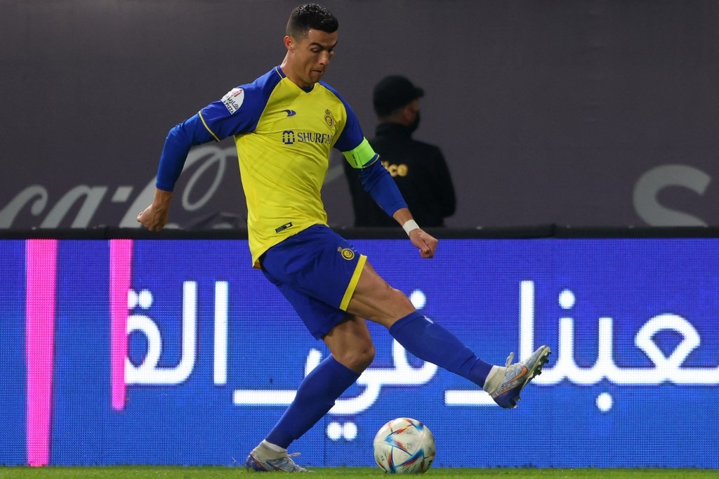 Nassr's Portuguese forward Cristiano Ronaldo runs with the ball during the Saudi Pro League football match between Al-Nassr and Al-Ettifaq
