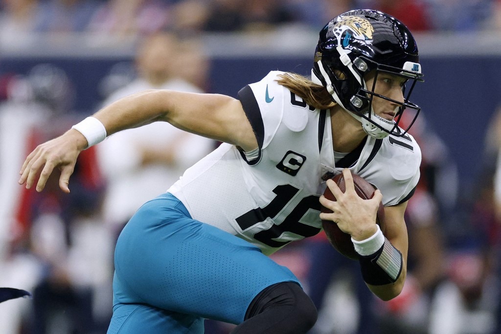 Trevor Lawrence #16 of the Jacksonville Jaguars carries the ball against the Houston Texans
