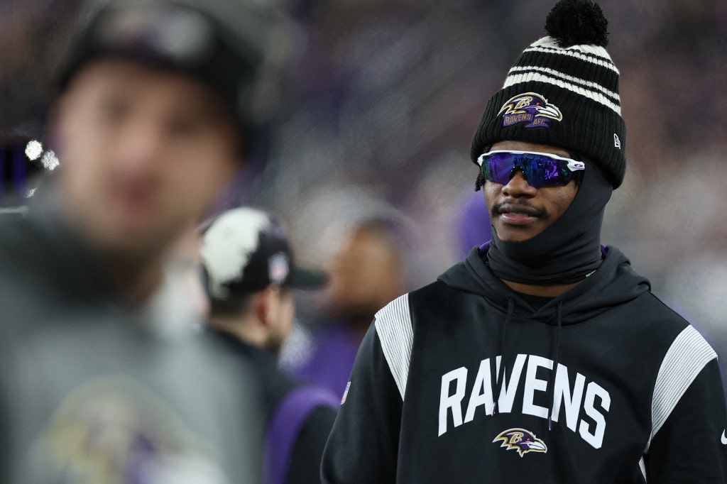 Quarterback Lamar Jackson #8 of the Baltimore Ravens looks on from the sideline