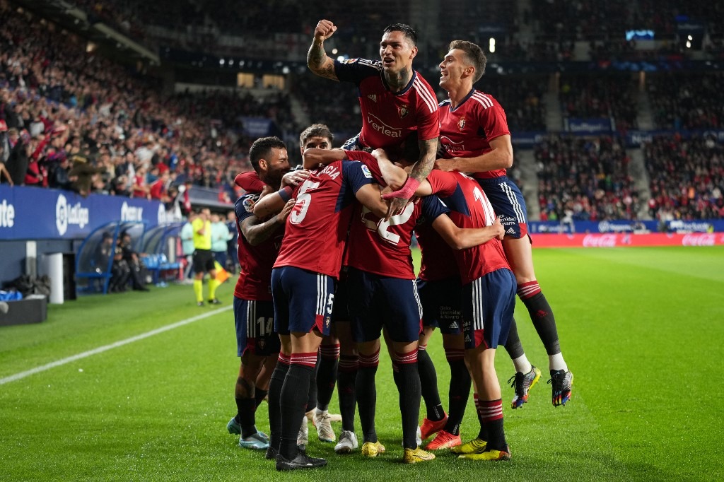 Osasuna's Spanish defender David Garcia (2nd-L) celebrates with teammates after scoring his team's first goal during the Spanish league football match between CA Osasuna and FC Barcelona