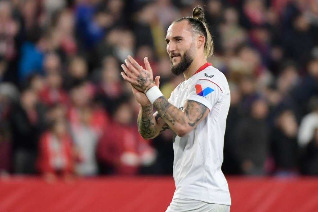 Sevilla's Serbian midfielder Nemanja Gudelj celebrates at the end of the UEFA Europa League round of 32 football match between Sevilla FC and PSV Eindhoven