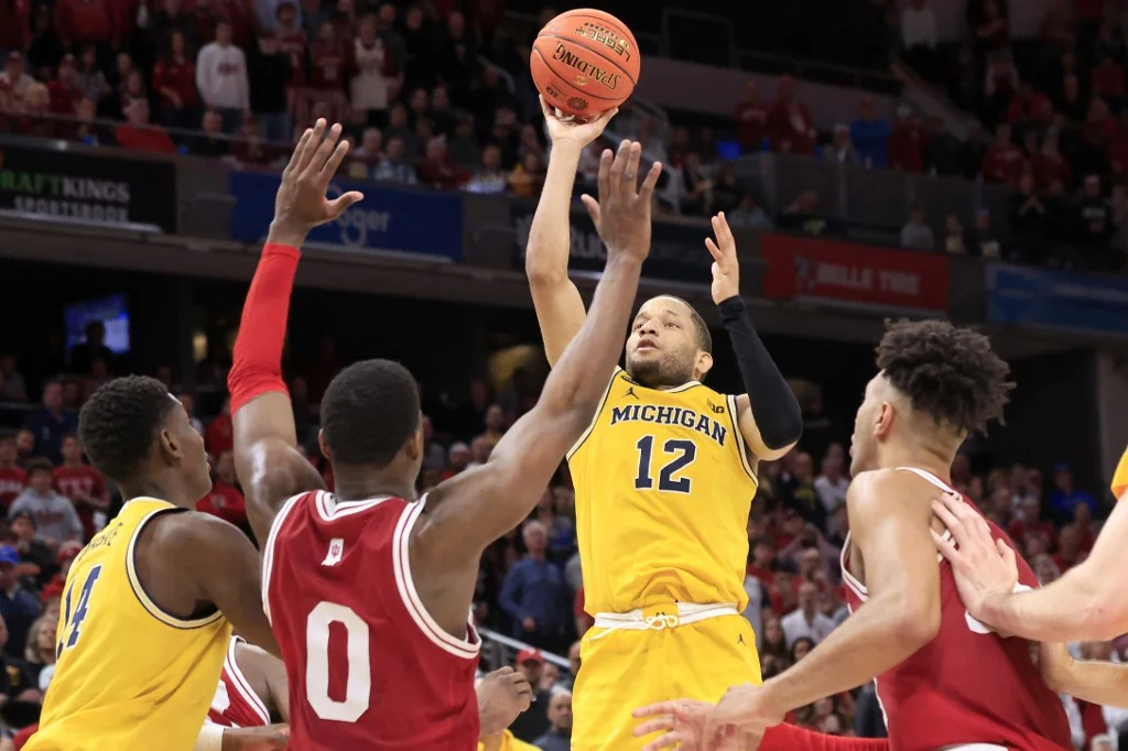 DeVante' Jones #12 of the Michigan Wolverines takes a shot in the second half against the Indiana Hoosiers during the Big Ten Tournament at Gainbridge Fieldhouse on March 10, 2022