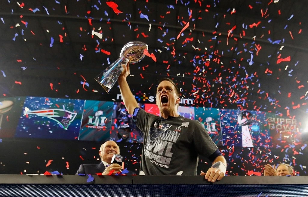 Tom Brady #12 of the New England Patriots raises the Vince Lombardi Trophy after defeating the Atlanta Falcons during Super Bowl 51