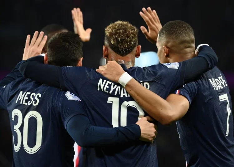 Paris Saint-Germain's Brazilian forward Neymar (C) celebrates after opening the scoring with Paris Saint-Germain's Argentine forward Lionel Messi (L) and Paris Saint-Germain's French forward Kylian Mbappe