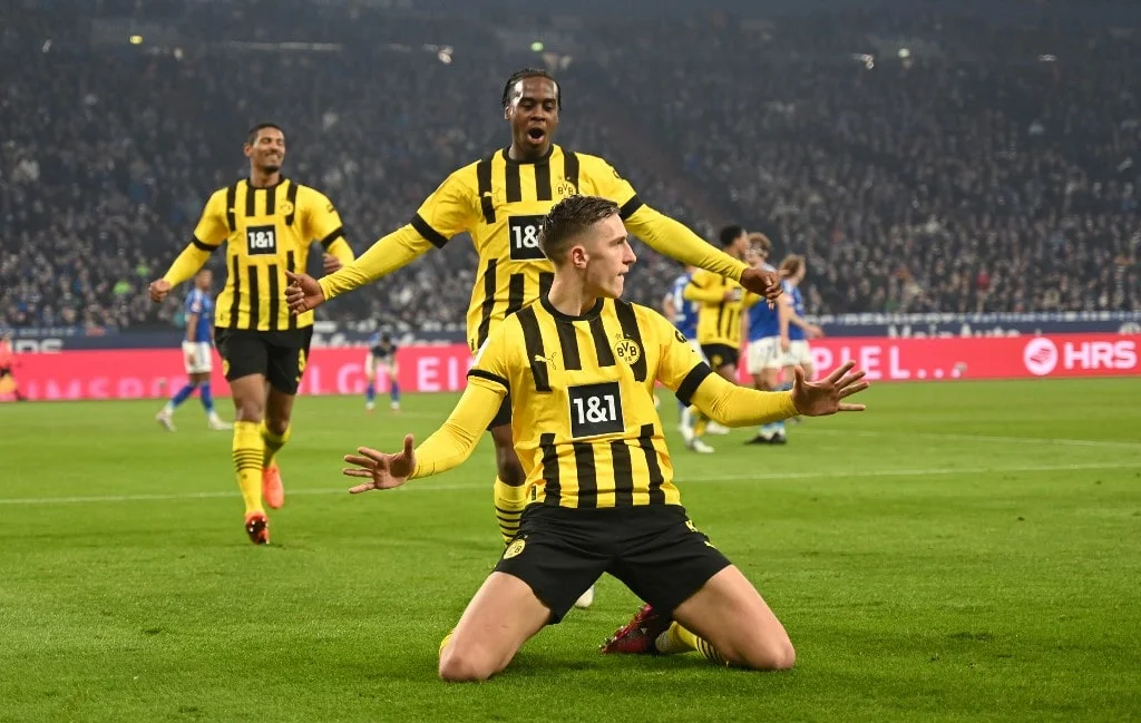 Dortmund's German defender Nico Schlotterbeck (Bottom) celebrates