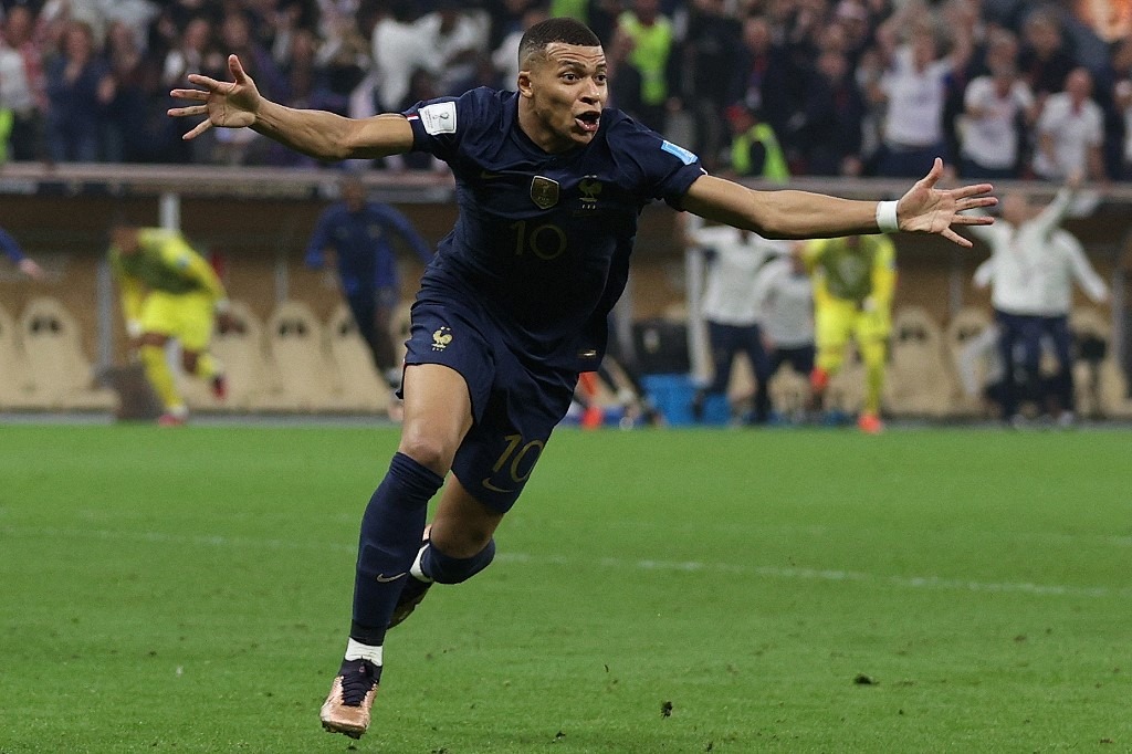 France's forward #10 Kylian Mbappe celebrates scoring his team's second goal during the Qatar 2022 World Cup final football match between Argentina and France at Lusail Stadium in Lusail