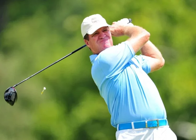 Steve Elkington of Australia watches his tee shot on the 14th hole