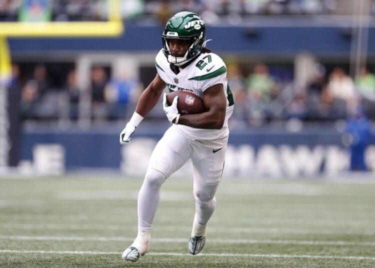 Zonovan Knight #27 of the New York Jets runs with the ball during the first half in the game against the Seattle Seahawks at Lumen Field on January 01, 2023