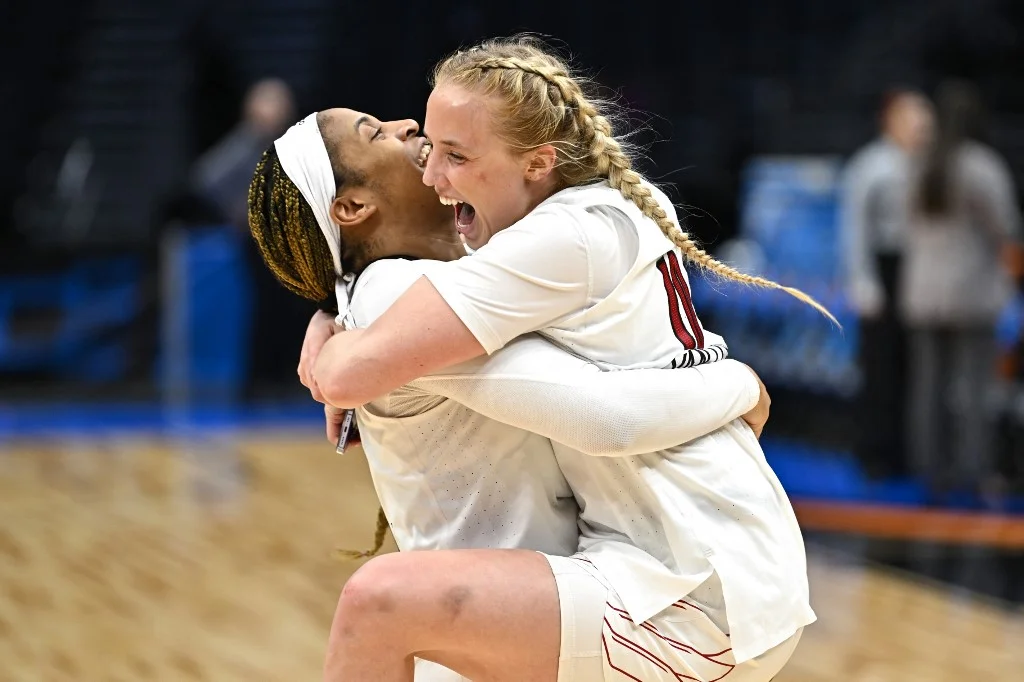 Merissah Russell #13 and Hailey Van Lith #10 of the Louisville Cardinals celebrate after defeating the Ole Miss Rebels in the Sweet 16 round of the NCAA Women's Basketball Tournament at Climate Pledge Arena on March 24, 2023