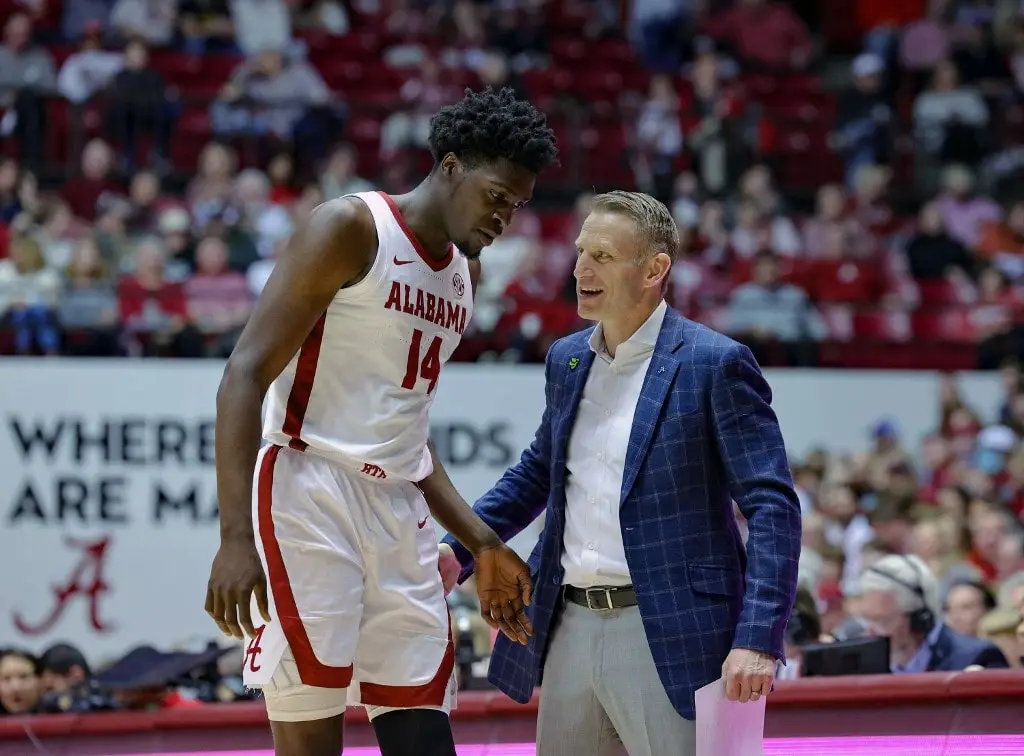 Charles Bediako #14 of the Alabama Crimson Tide gets second half instruction from head coach Nate Oats
