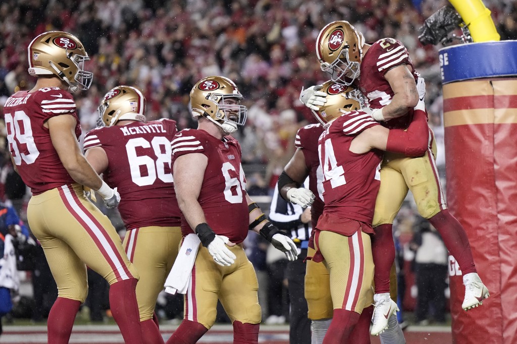 Christian McCaffrey #23 of the San Francisco 49ers celebrates with teammates. Thearon W. Henderson/Getty Images/AFP